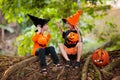 Asian kids with pumpkins in Halloween costumes