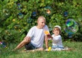 Children blow bubbles