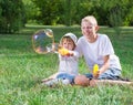 Children blow bubbles Royalty Free Stock Photo