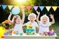 Children blow candles on birthday cake. Kids party Royalty Free Stock Photo