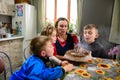 Children blow out candles on a name cake, a delicious dessert for a birthday, bright and colorful candles