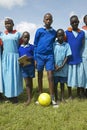 Children in blue uniforms holding soccer ball at school near Tsavo National Park, Kenya, Africa