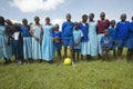 Children in blue uniforms holding soccer ball at school near Tsavo National Park, Kenya, Africa