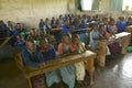 Children in blue uniforms in school behind desk near Tsavo National Park, Kenya, Africa