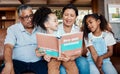 Children book, reading smile and grandparent helping kids with learning and story. House, living room and black family Royalty Free Stock Photo