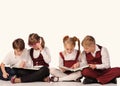 children with books siiting on the floor