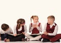 children with books siiting on the floor