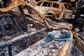 Children boots on top of destroyed car in Bucha Royalty Free Stock Photo