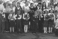 Children with bouquets of flowers enrolled in the first class at school at the inauguration of the school year in the day of knowl Royalty Free Stock Photo