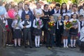 Children with bouquets of flowers enrolled in the first class at school at the inauguration of the school year in the day of knowl Royalty Free Stock Photo