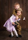 Children boy are dressed as soldier in retro military uniforms and girl in pink dress Royalty Free Stock Photo