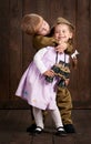 Children boy are dressed as soldier in retro military uniforms and girl in pink dress Royalty Free Stock Photo