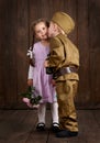 Children boy are dressed as soldier in retro military uniforms and girl in pink dress Royalty Free Stock Photo