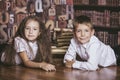 Children boy and girl children reading books in library Royalty Free Stock Photo