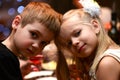 Children boy with girl drink together and cuddle on holiday