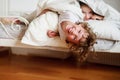 Children, boy and girl indulge on the bed in the bedroom.