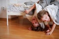 Children, boy and girl indulge on the bed in the bedroom.