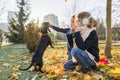 Children boy and girl playing with dachshund dog in a sunny autumn park Royalty Free Stock Photo
