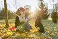 Children boy and girl playing with dachshund dog in a sunny autumn park Royalty Free Stock Photo