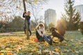 Children boy and girl playing with dachshund dog in a sunny autumn park Royalty Free Stock Photo