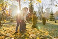 Children boy and girl playing with dachshund dog in a sunny autumn park Royalty Free Stock Photo