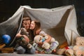 Children boy and girl playing and frighten each other with flashlight in tent at night Royalty Free Stock Photo