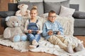 Children boy and girl playing on video games. Pretty little girl and boy are playing game console. Gaming video games concept. Royalty Free Stock Photo