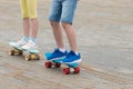 Children boy and girl ride skateboards on a city street