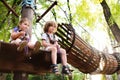 Children - a boy and a girl in the rope park pass obstacles Royalty Free Stock Photo