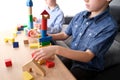 Children, boys builds towers and buildings from colored wooden figures, the concept of housing construction, mortgage, insurance, Royalty Free Stock Photo