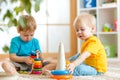 Children boys with toys in playroom