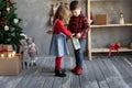 Children brother and sister with gift packages advent calendar number 1, handmade calendar in craft packaging, diy gifts