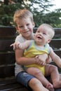 Children brothers sitting on bench