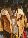 Children brown jacket with a price tag on a hanger in the store