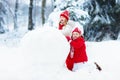 Kids building snowman. Children in snow. Winter fun. Royalty Free Stock Photo