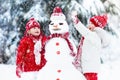 Kids building snowman. Children in snow. Winter fun. Royalty Free Stock Photo