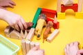 Children build a zoo of wooden bricks on table Royalty Free Stock Photo