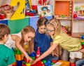 Children building blocks in kindergarten. Group kids playing toy floor . Royalty Free Stock Photo