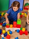 Children building blocks in kindergarten. Group kids playing toy floor. Royalty Free Stock Photo