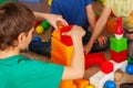 Children building blocks in kindergarten. Group kids playing toy floor . Royalty Free Stock Photo