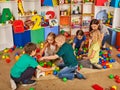 Children building blocks in kindergarten. Group kids playing toy floor . Royalty Free Stock Photo