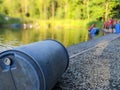 Children building rafts out of blue barrels on the water