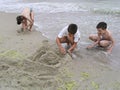 Children are building sand castles on the beach Royalty Free Stock Photo