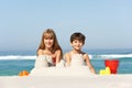 Children Building Sandcastles On Beach Holiday