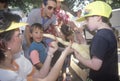 Children with a Burmese albino python snake