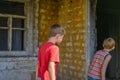 Children in a burnt house lost their homes as a result of hostilities and natural disasters