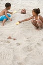 Children burying father in sand Royalty Free Stock Photo