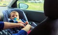 Children car chair. baby car seat for safety. boy in the child seat and his mother, safe driving protocol Royalty Free Stock Photo