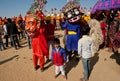 Children in carnival crowd with scary evil characters