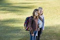 Children carrying backpacks outdoors